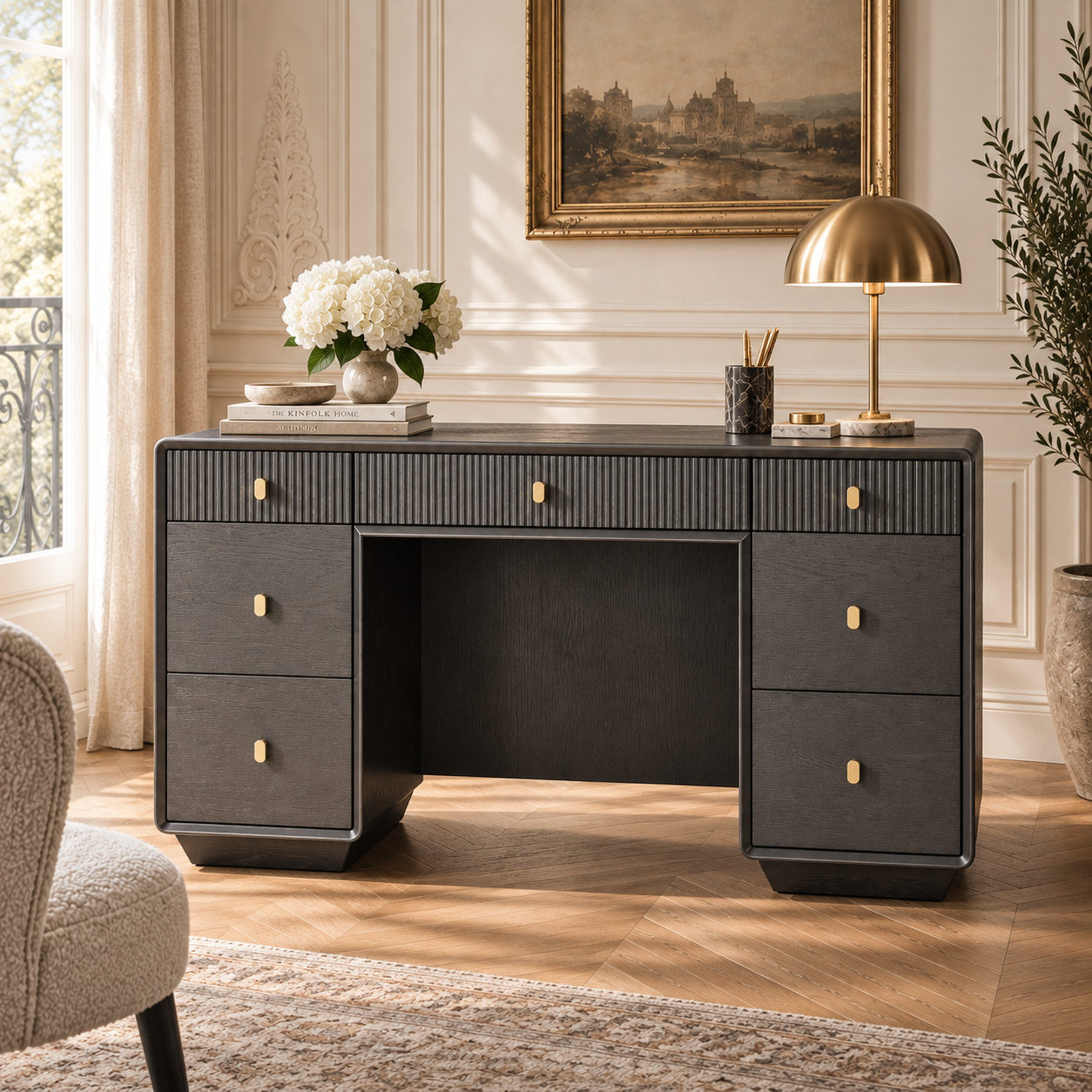 Oréliane brown grey fluted 7 drawer dressing table styled with brass lamp and flowers in a Parisian bedroom.
