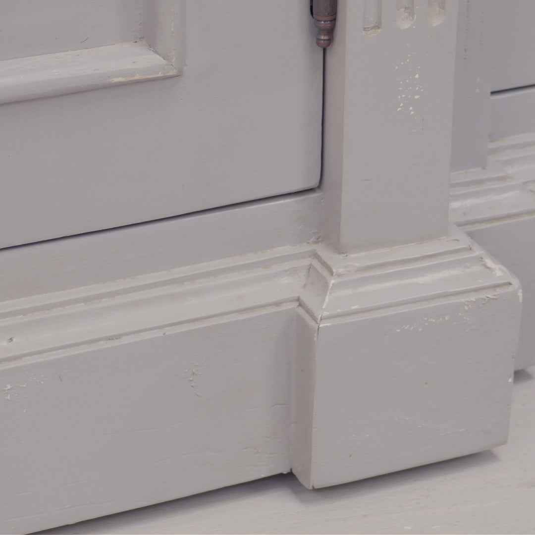Video of Laurent distressed mahogany bookcase showing painted finish, panelled doors and decorative moulding on white