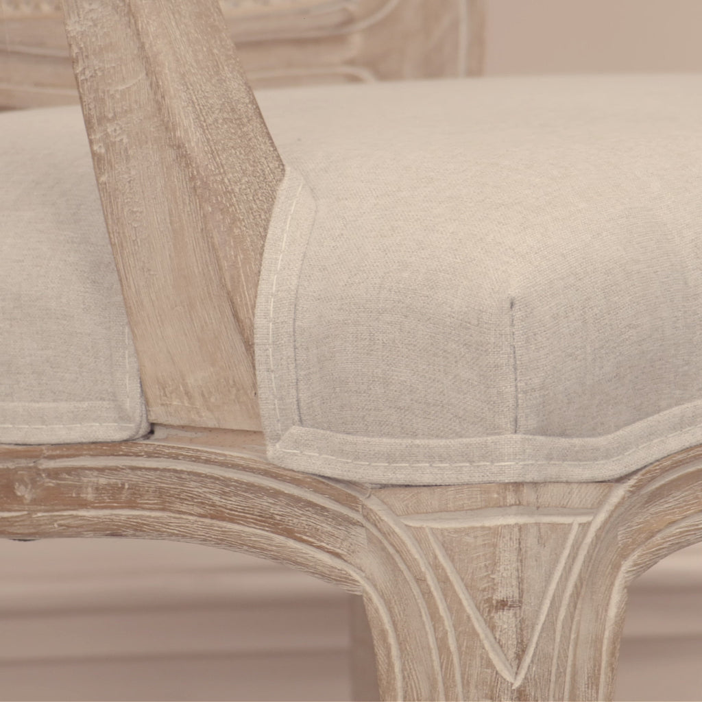 Video of Camille French Louis birch wood dining armchair showing cane back, linen seat and distressed wood finish