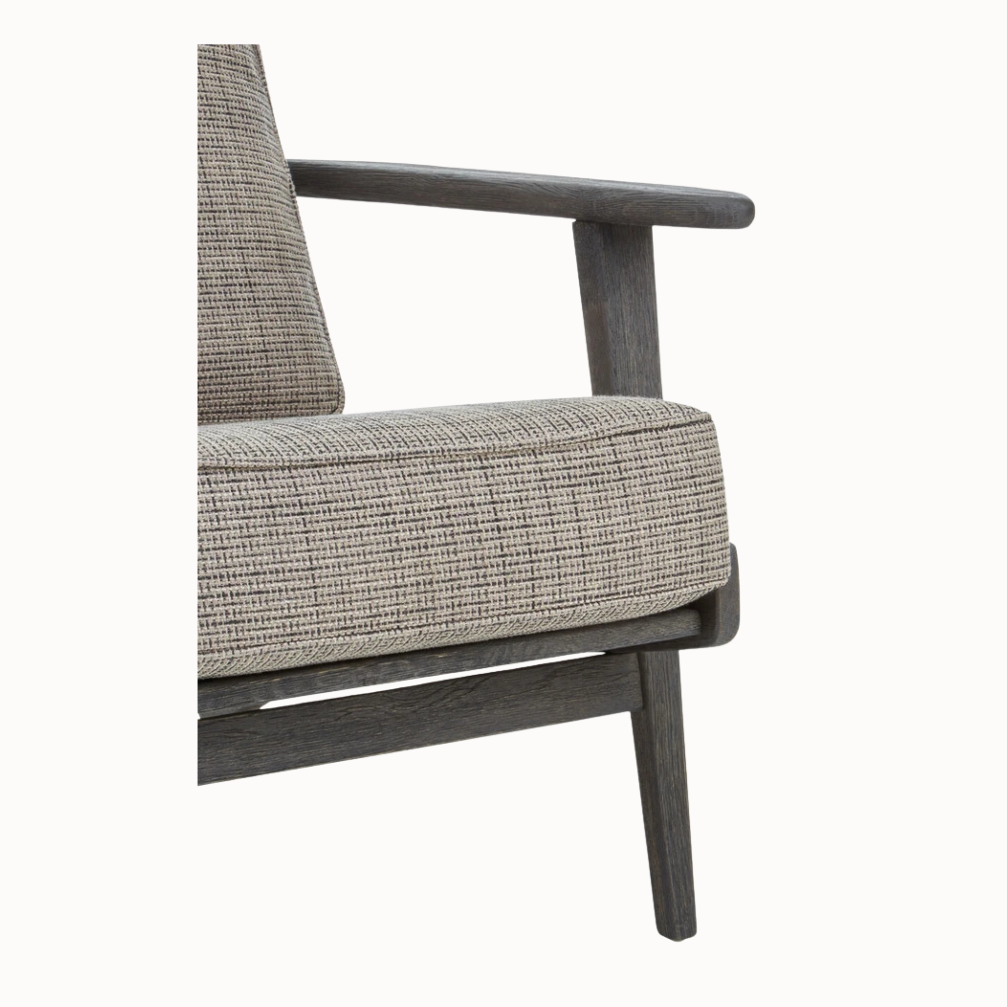 Close-up of Rémi grey tweed armchair upholstery and black American oak armrest against a plain white background.