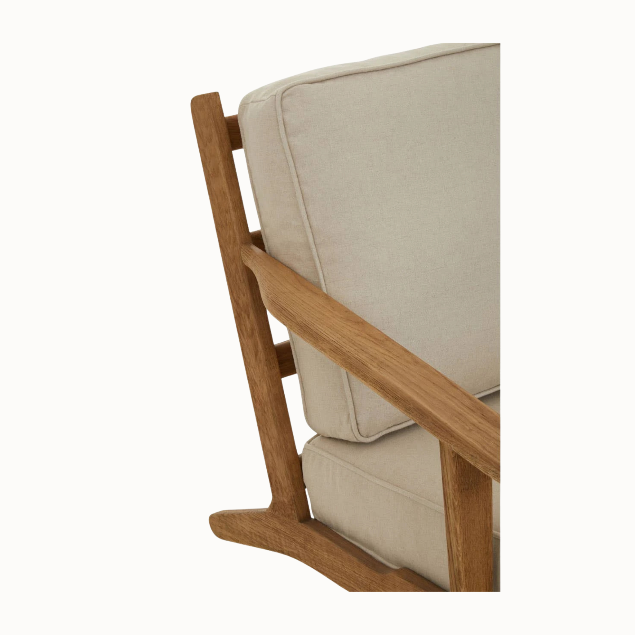 Close-up of Rémi linen armchair back cushion and dark American oak frame on a plain white background.