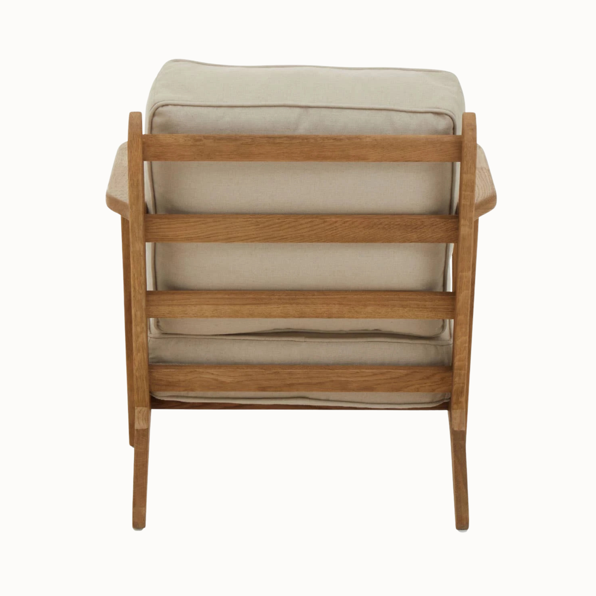 Rear view of Rémi natural linen armchair with dark American oak slatted frame on a plain white background.