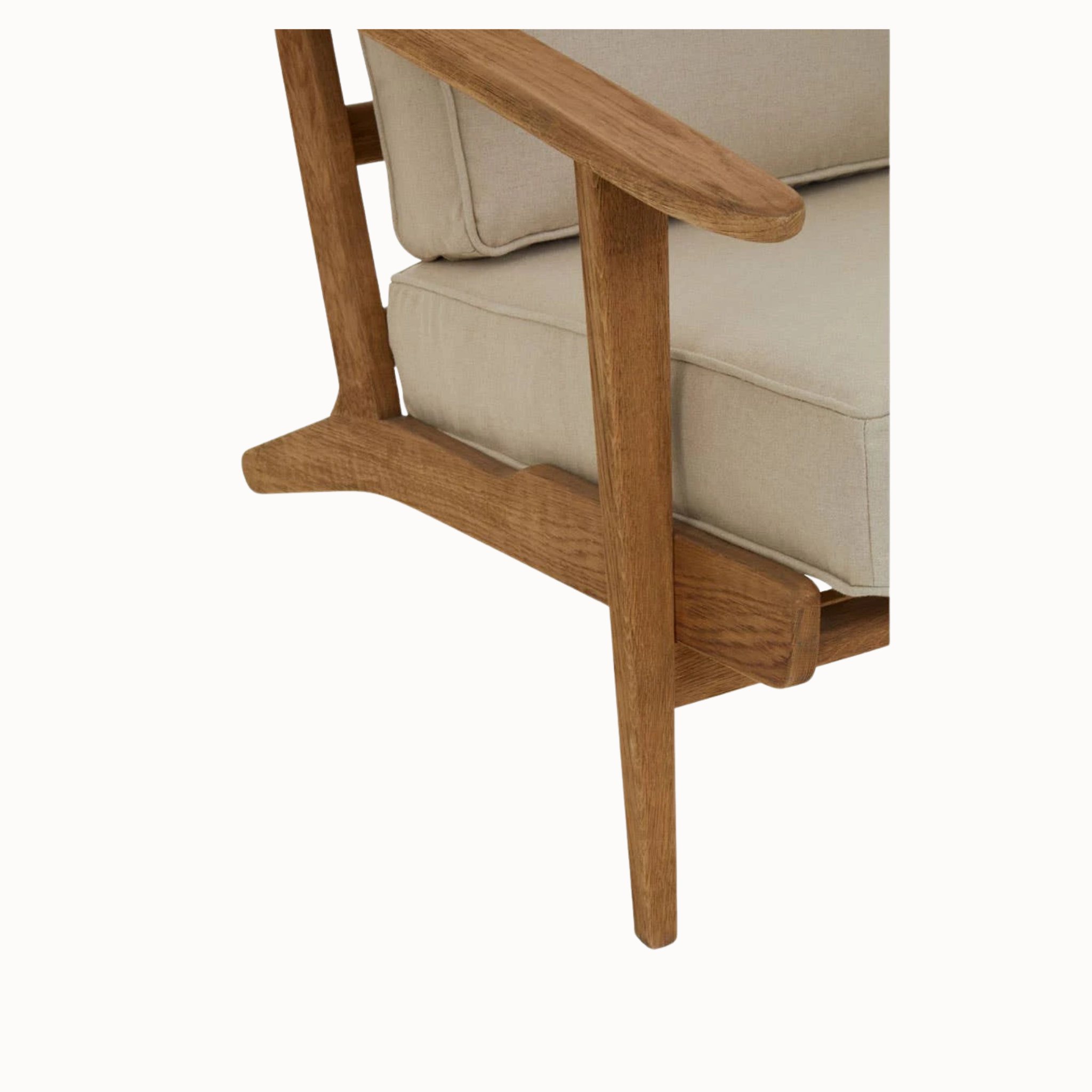 Rémi linen armchair detail showing dark American oak arm, frame and cushioned seat on a plain white background.
