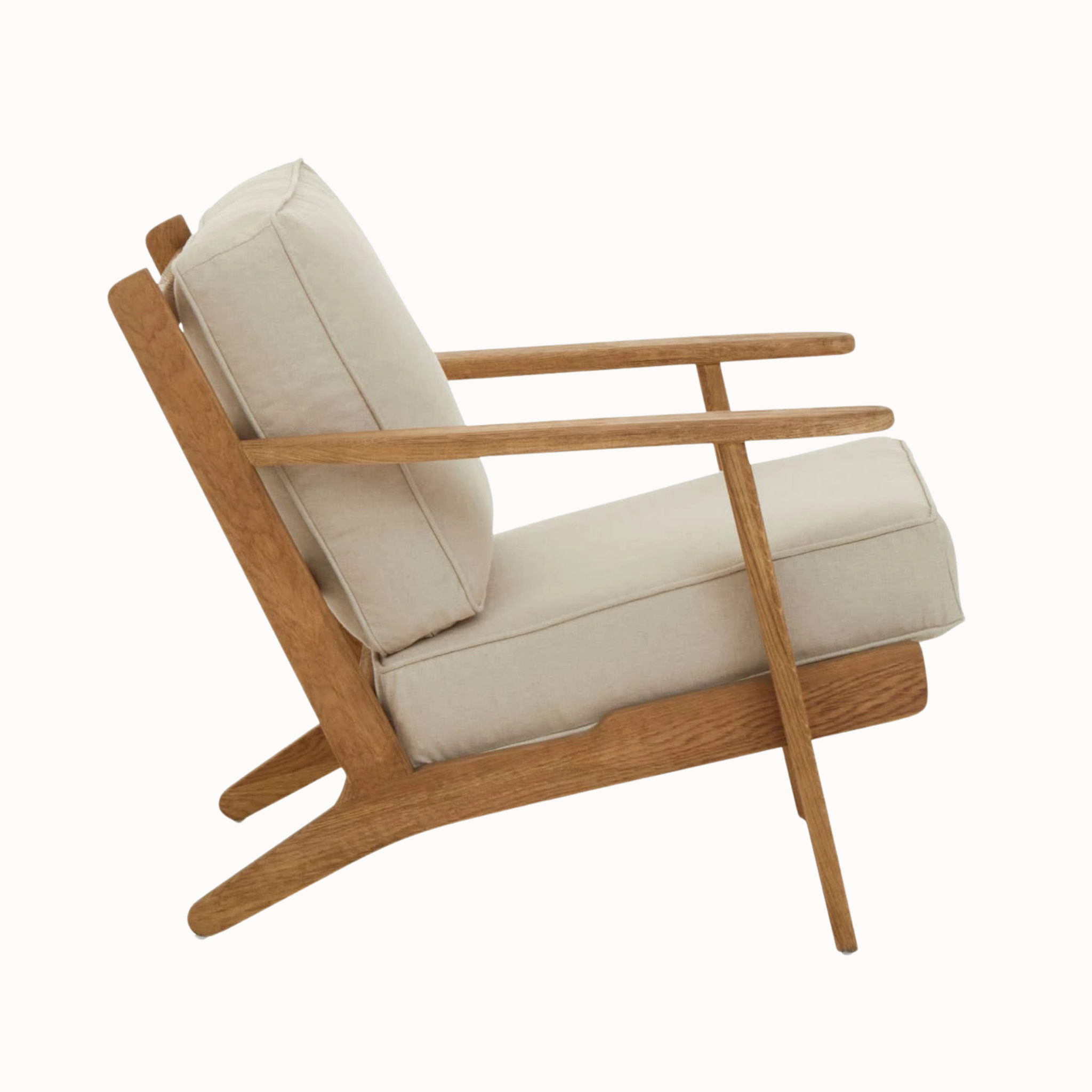 Side view of Rémi natural linen and dark American oak wood armchair on a plain white background.