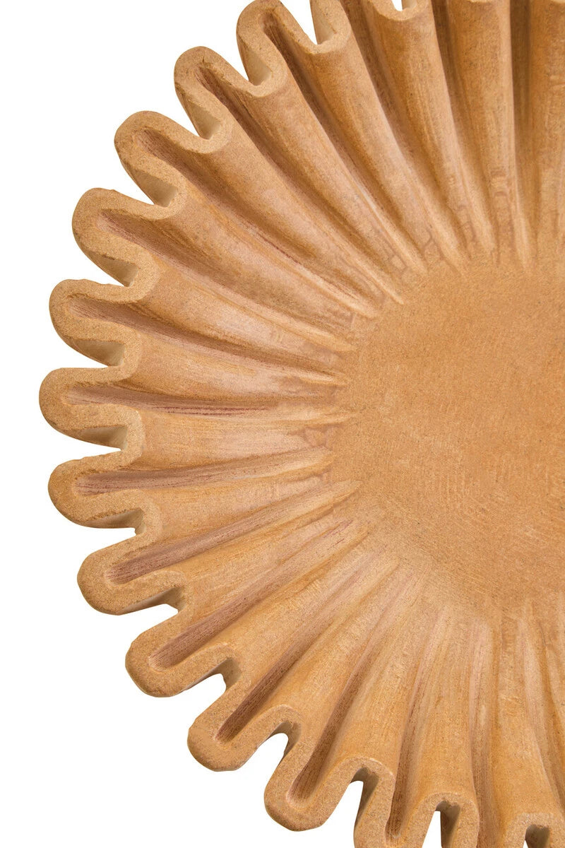 Close-up of Renaud ochre marble decorative bowl showing fluted scalloped rim and carved grooves on a white background.