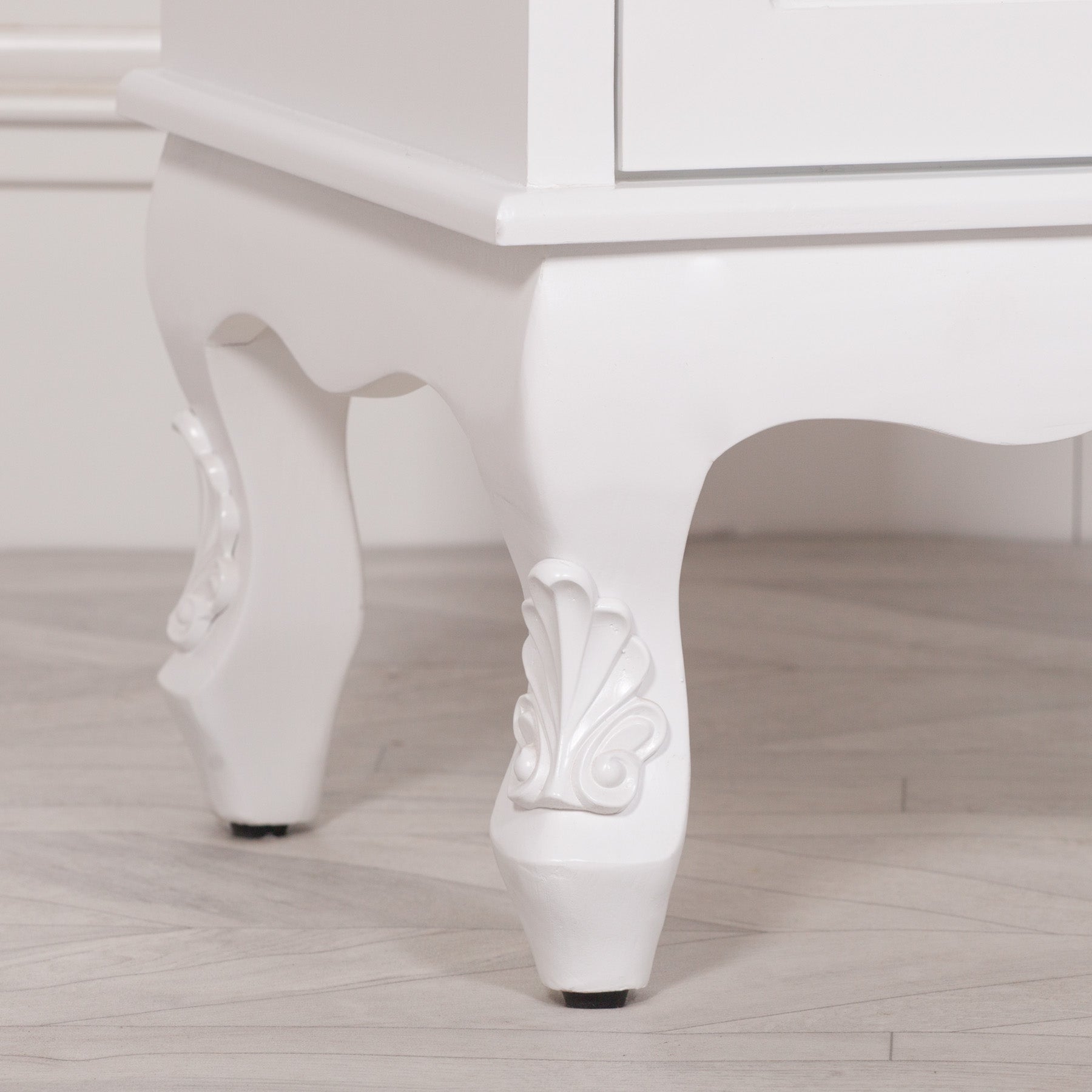 Close-up of the carved cabriole feet and decorative base on the Rosalie Tall French Glass Display Cabinet with Drawer in Antique White, showcasing handcrafted French furniture detailing and elegant antique styling.