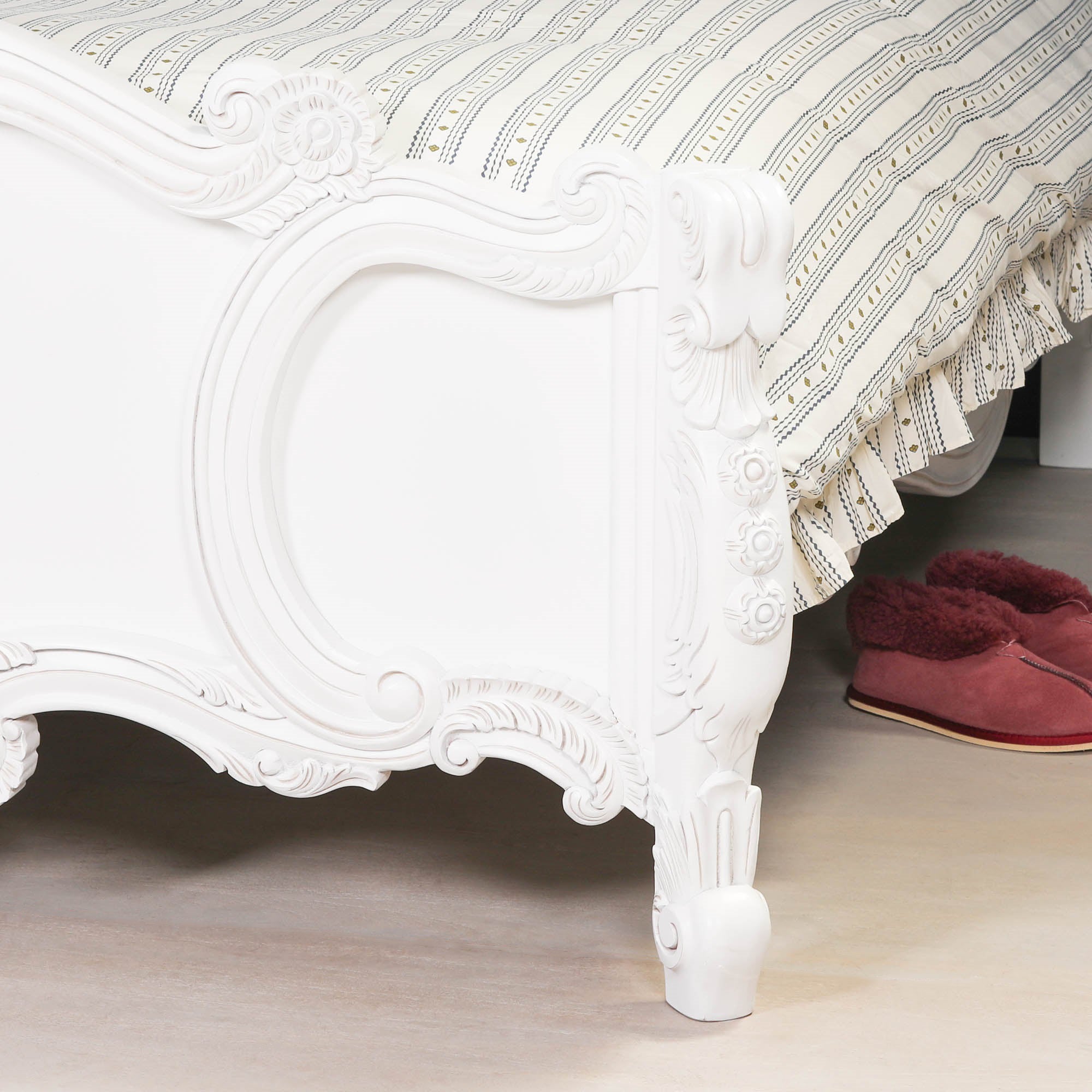 Detailed close-up of the Rosalie French Rococo 4ft6 double bed frame footboard featuring elegant hand-carved scrollwork, floral detailing and curved cabriole leg in a light painted white finish.