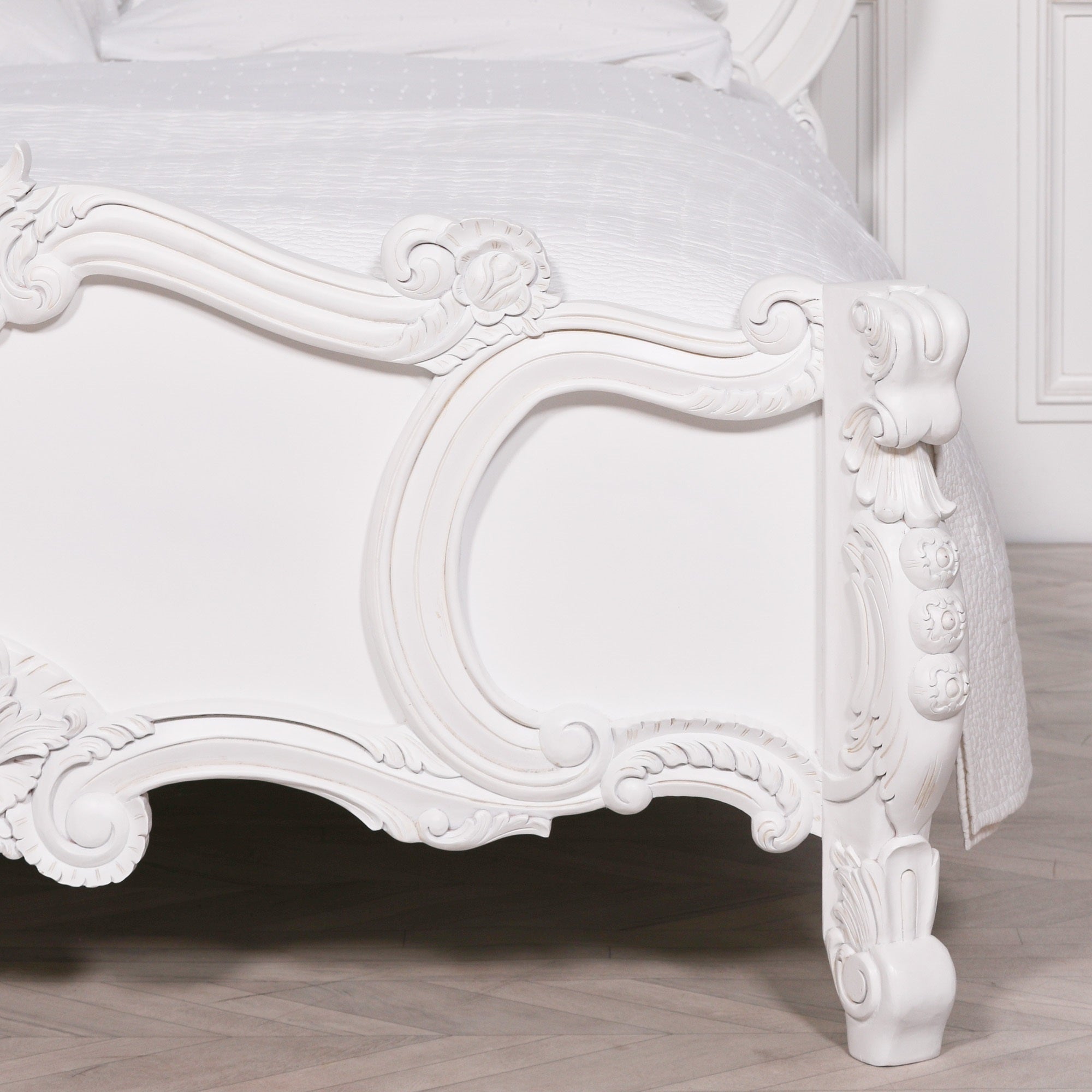 Front close-up of the Rosalie French Rococo footboard showcasing intricate hand-carved rose and cherub detailing with elegant curved French styling in a light painted white finish.