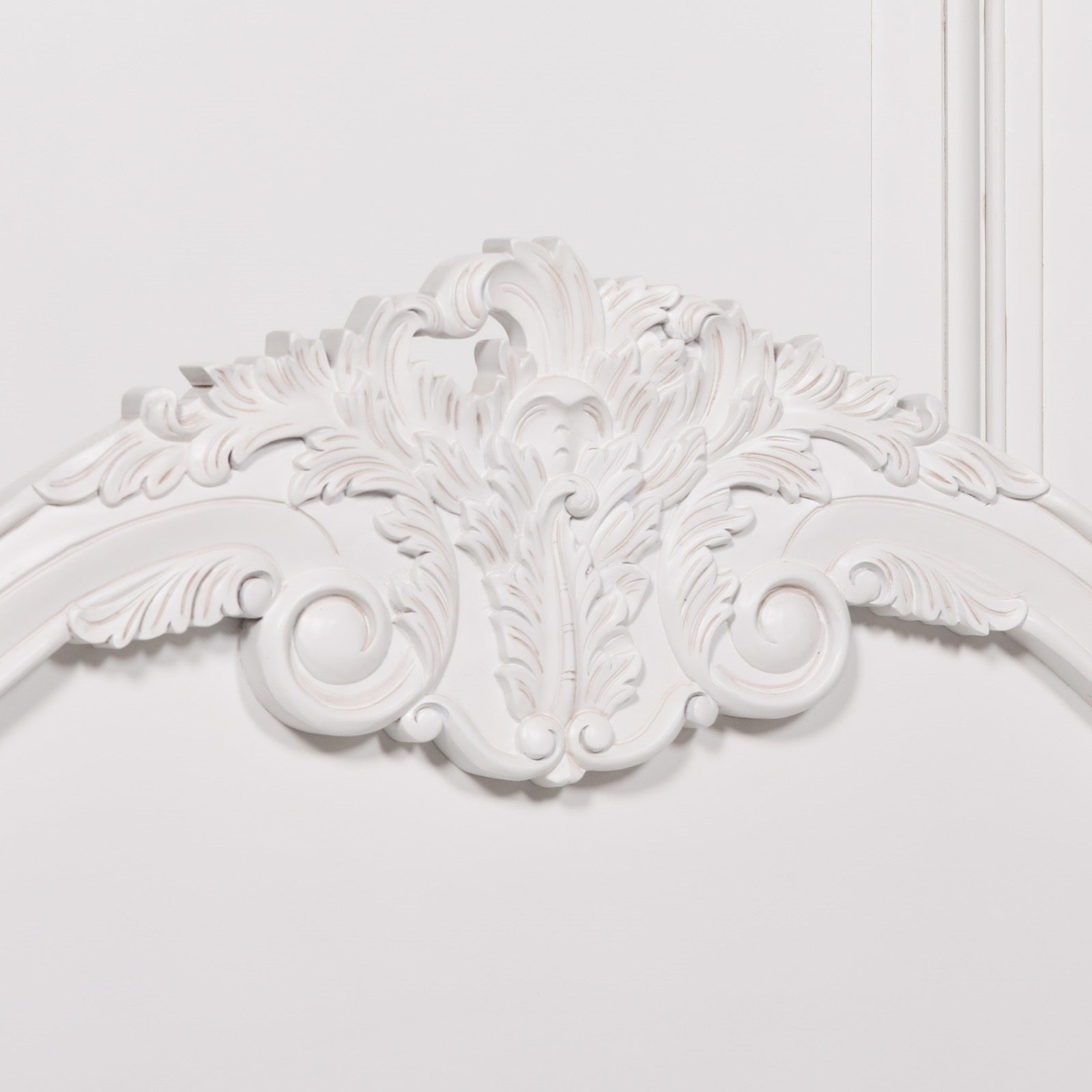 Close-up of the decorative crest on the Rosalie French Rococo bed headboard featuring elaborate hand-carved floral scrollwork, rose motifs and French-inspired detailing.