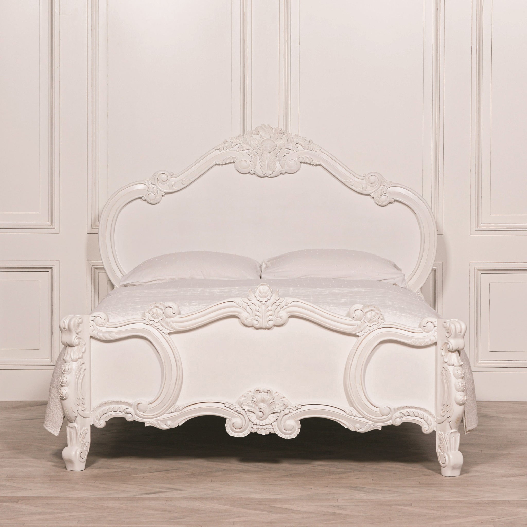 Front view of the Rosalie French Rococo 5FT king size bed frame in a light panelled bedroom, featuring a painted white finish and ornate hand-carved headboard and footboard