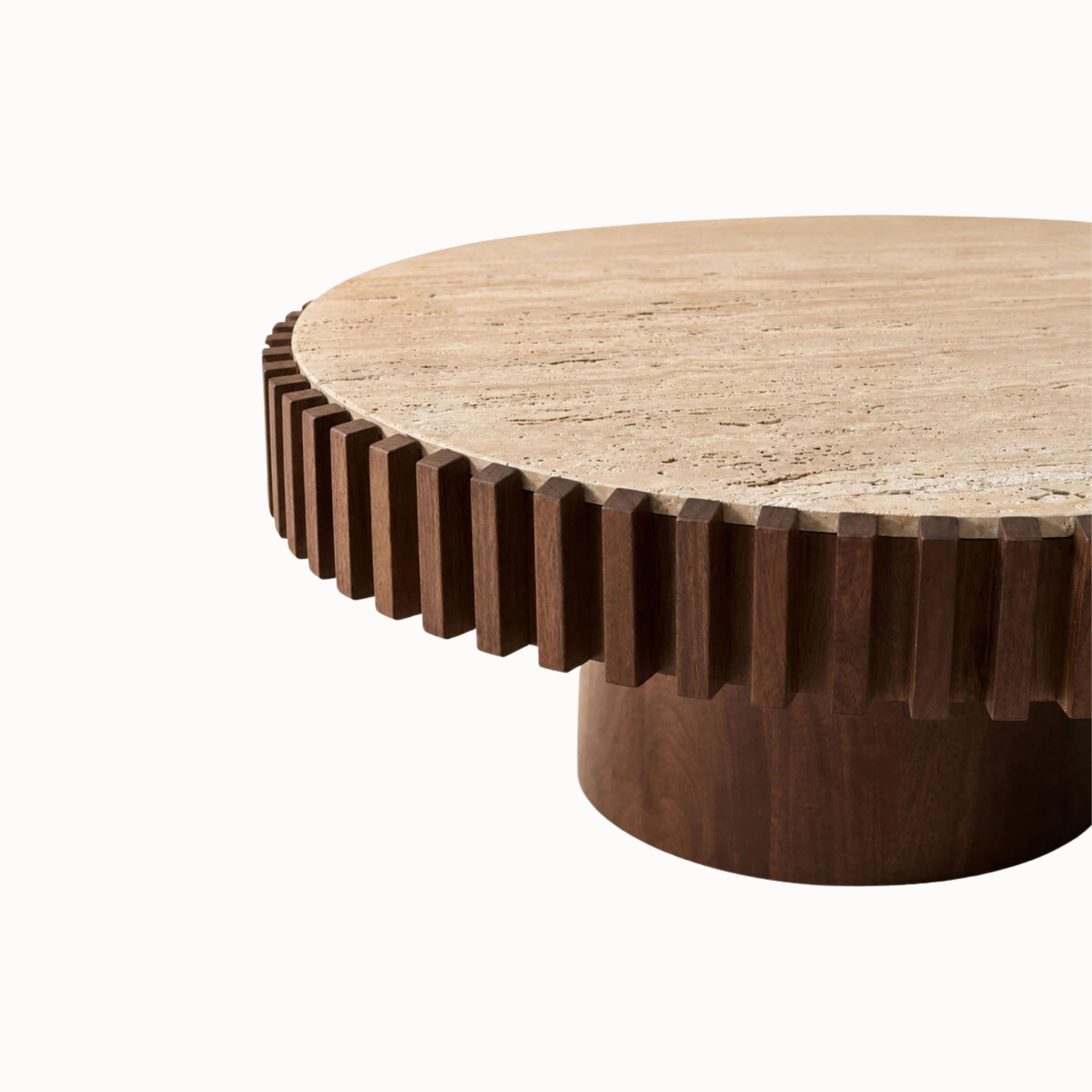 Close-up of round travertine coffee table with natural stone top, dark wood fluted edge and pedestal on white.