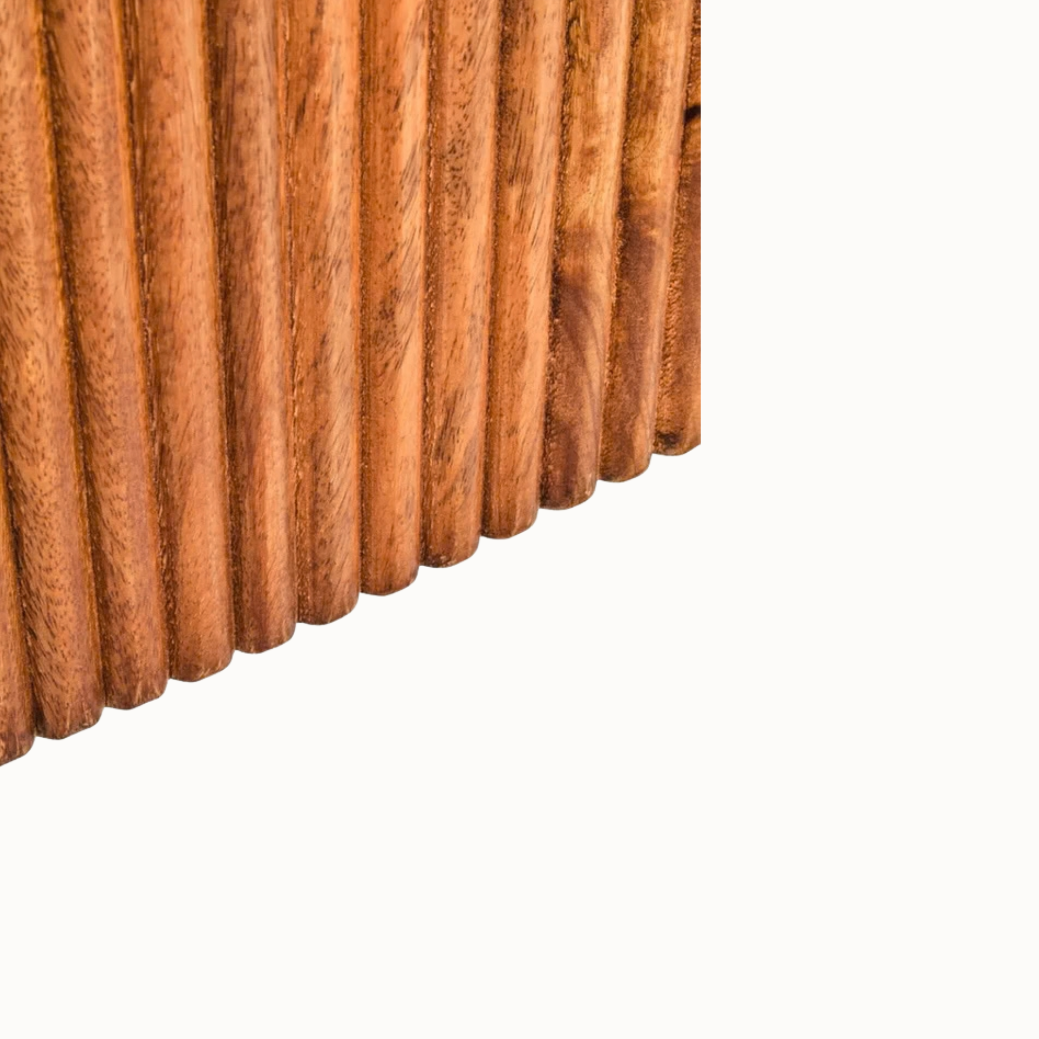 Close-up of Sabine solid mango wood ribbed pedestal base showing warm grain and carved vertical texture on white.