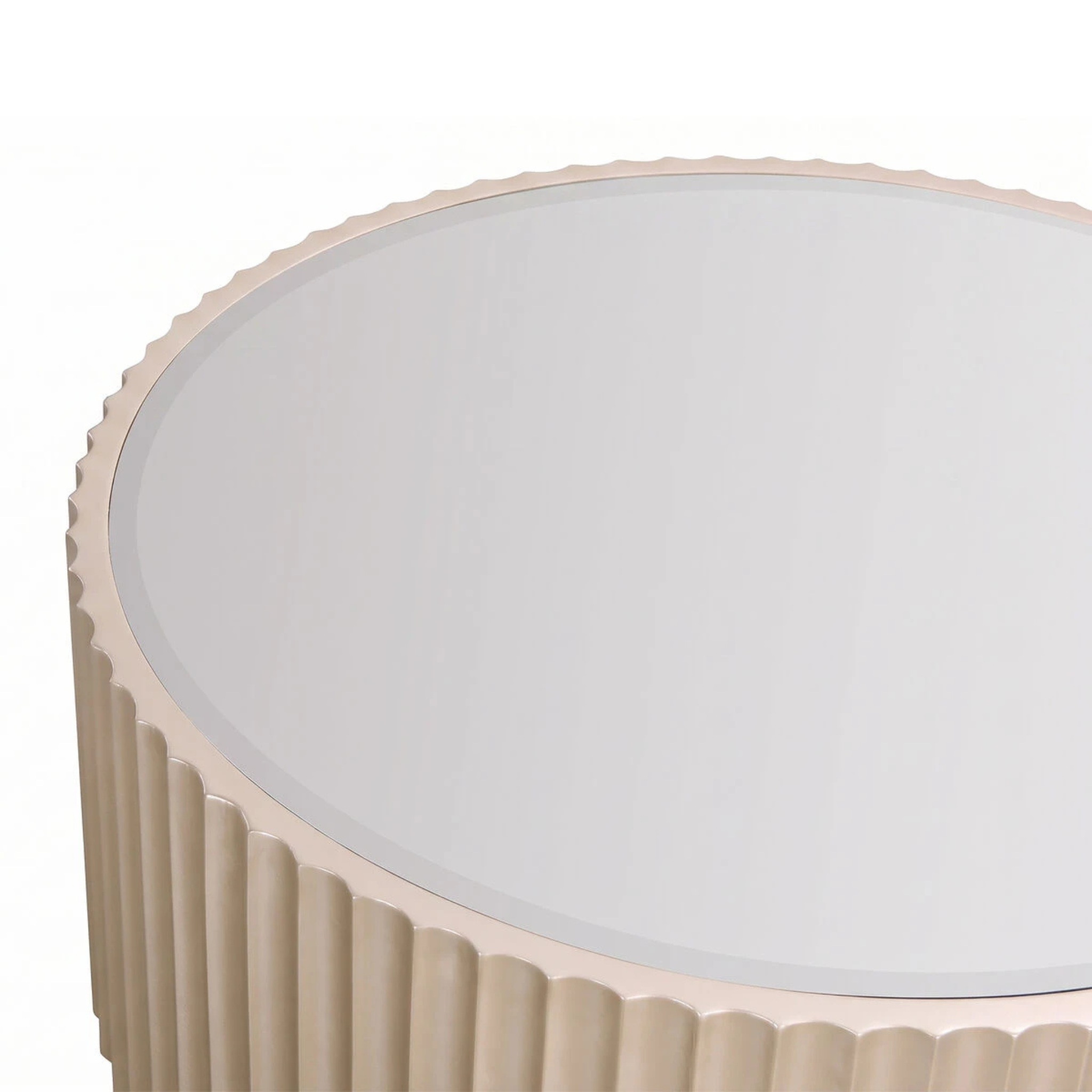 Close-up of Séraphine champagne gold fluted round coffee table with smoked mirror top on a white background.