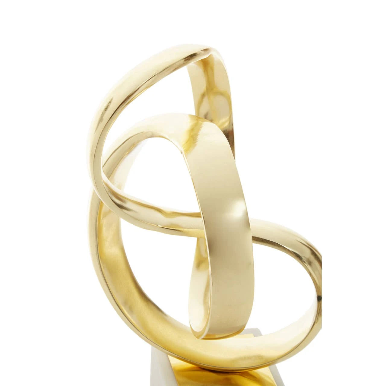 Close-up of Séverin gold aluminium knot sculpture highlighting interlocking curves on a clean white background.