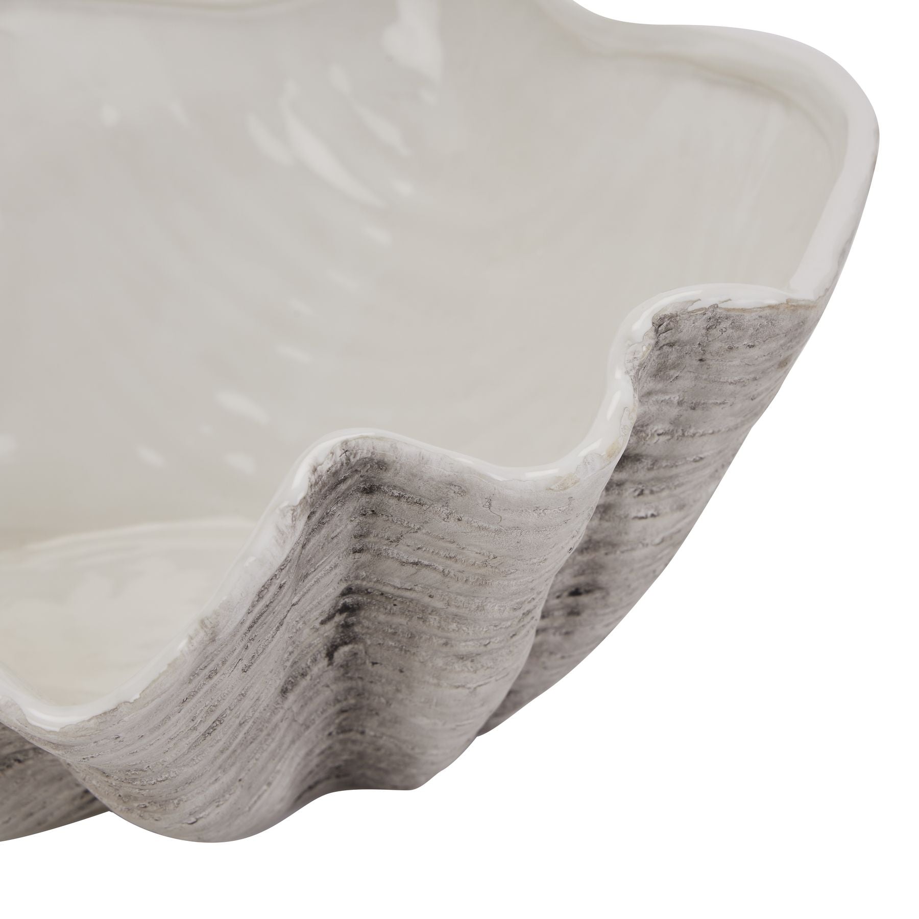 Close-up of Solange white ceramic shell bowl showing wavy rim and textured finish on a white background.