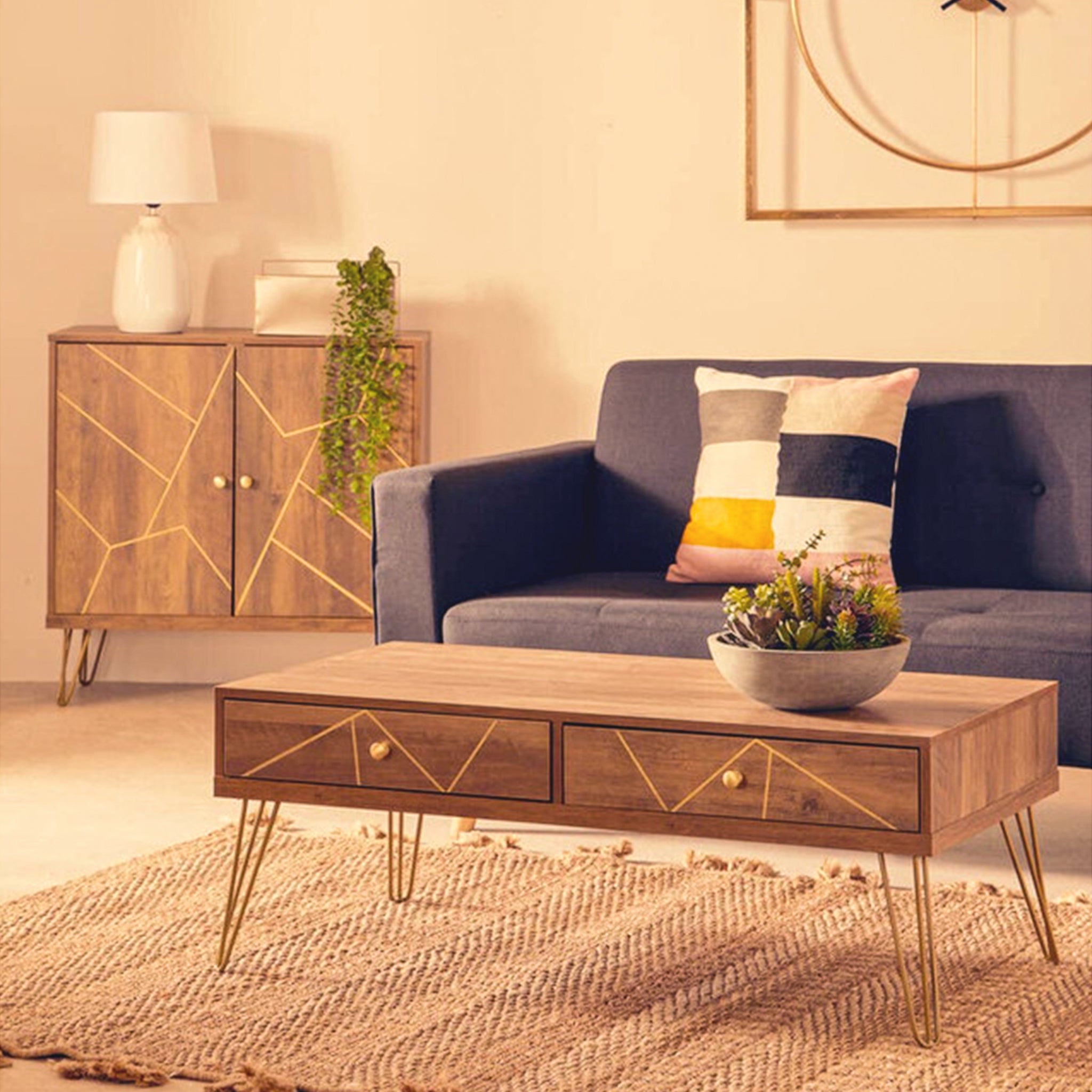 Soline Mid-Century Wooden Coffee Table with two drawers and gold hairpin legs styled in a contemporary living room with a sofa, textured rug and decorative accessories.