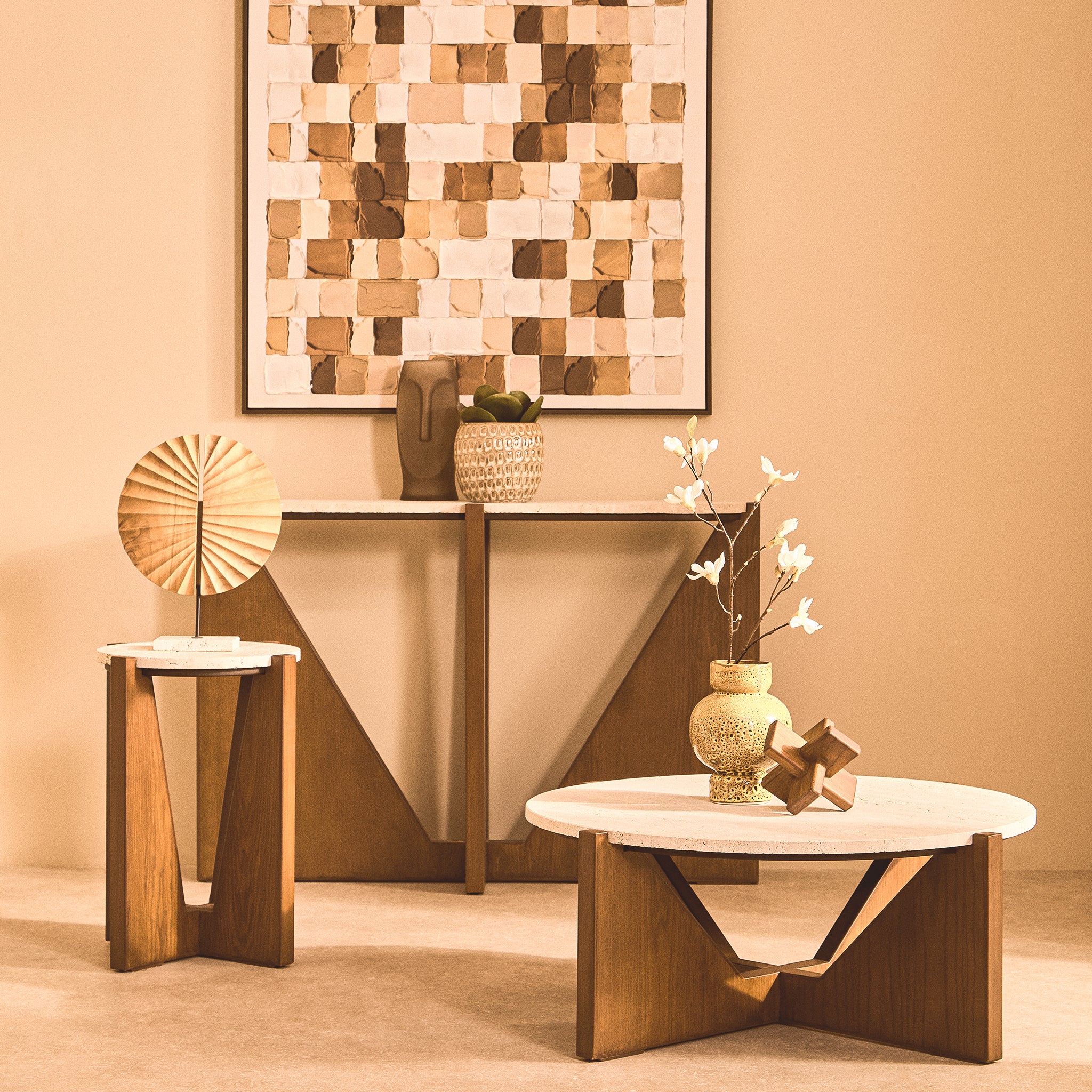 Soline travertine side table styled in a warm neutral living room alongside a matching round coffee table and acacia wood console table