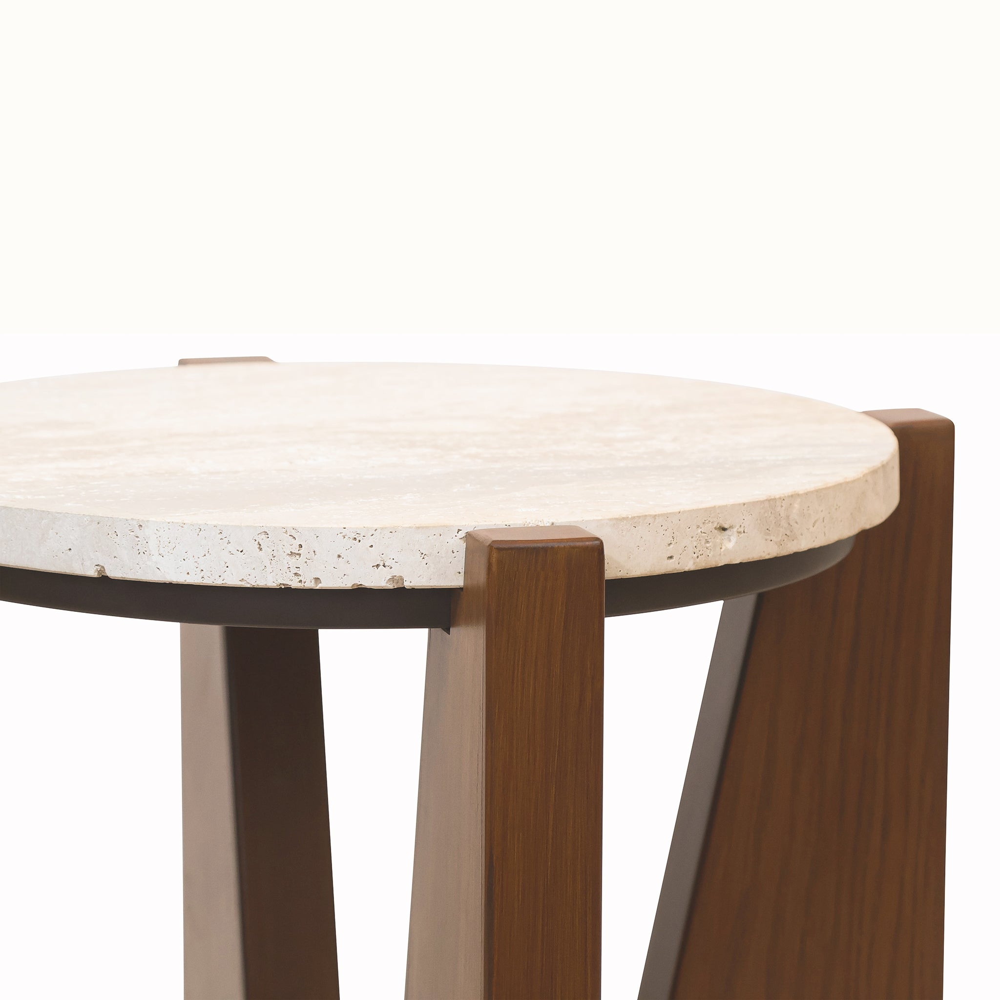 Close-up of the Soline Side Table highlighting the thick round travertine top, natural stone texture and sculptural acacia wood supports
