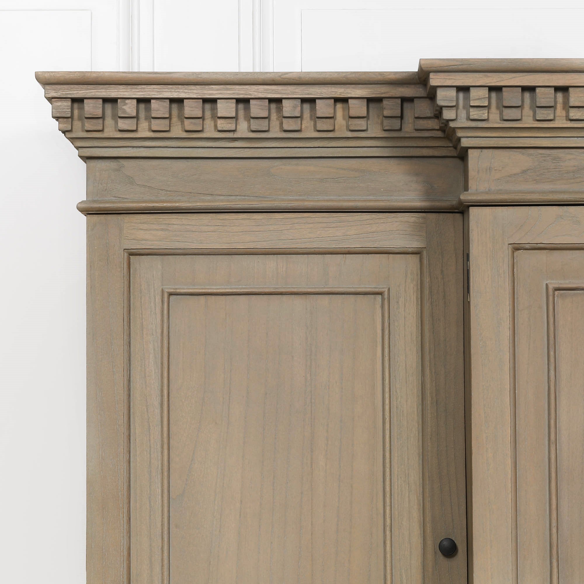 Close-up of the Théodore Extra Large Triple Breakfront TV Cabinet showcasing the handcrafted dentil cornice, rustic white cedar wood grain, traditional mouldings and premium cabinet craftsmanship.