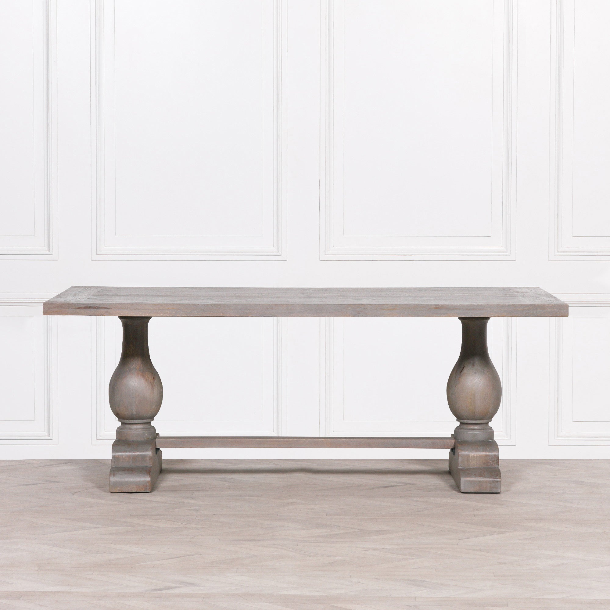 Front elevation of the Théodore Large Rectangular Dining Table 210cm for 8–10 in Rustic Mango Wood displaying the generous rectangular tabletop, handcrafted solid mango wood construction, turned pedestal legs and substantial trestle stretcher base for premium dining room interiors.