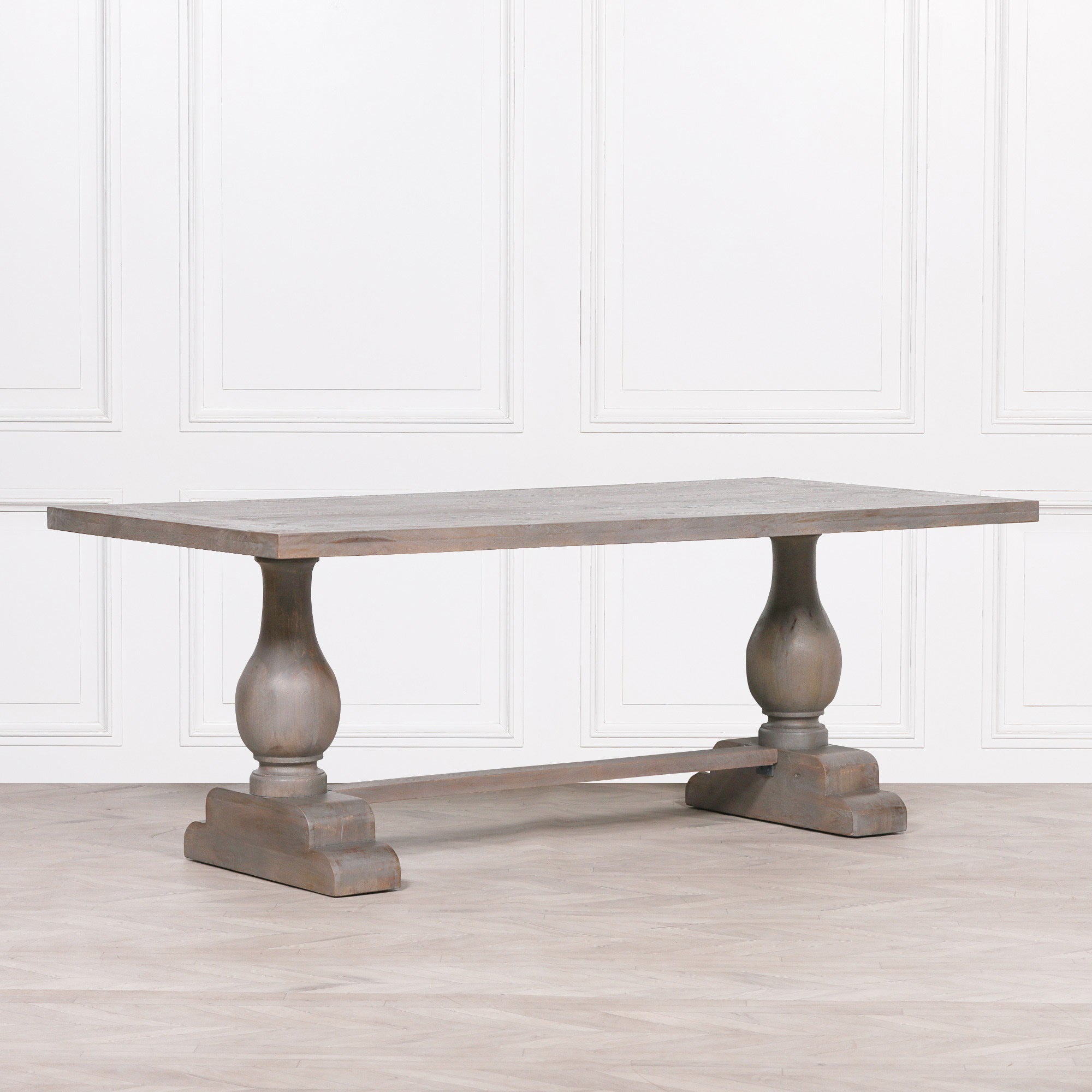Three-quarter view of the Théodore Large Rectangular Dining Table 210cm for 8–10 showcasing the expansive Rustic Mango Wood tabletop, sculptural turned pedestal legs, solid trestle base and timeless design for large family dining rooms.