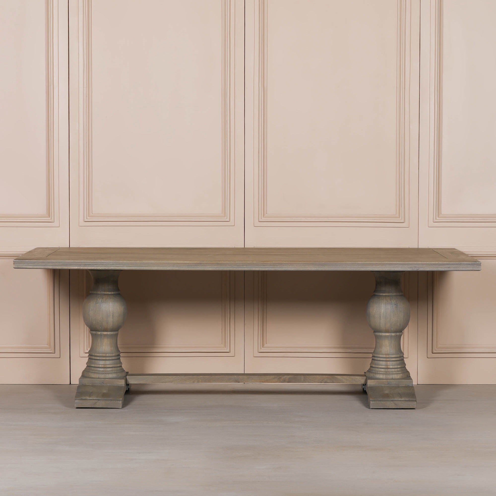 Front view of the Théodore Large Rectangular Dining Table 240cm for 10–12 in Rustic Mango Wood highlighting the spacious solid wood tabletop, twin turned pedestal legs and trestle stretcher base for large family dining spaces and luxury interiors.