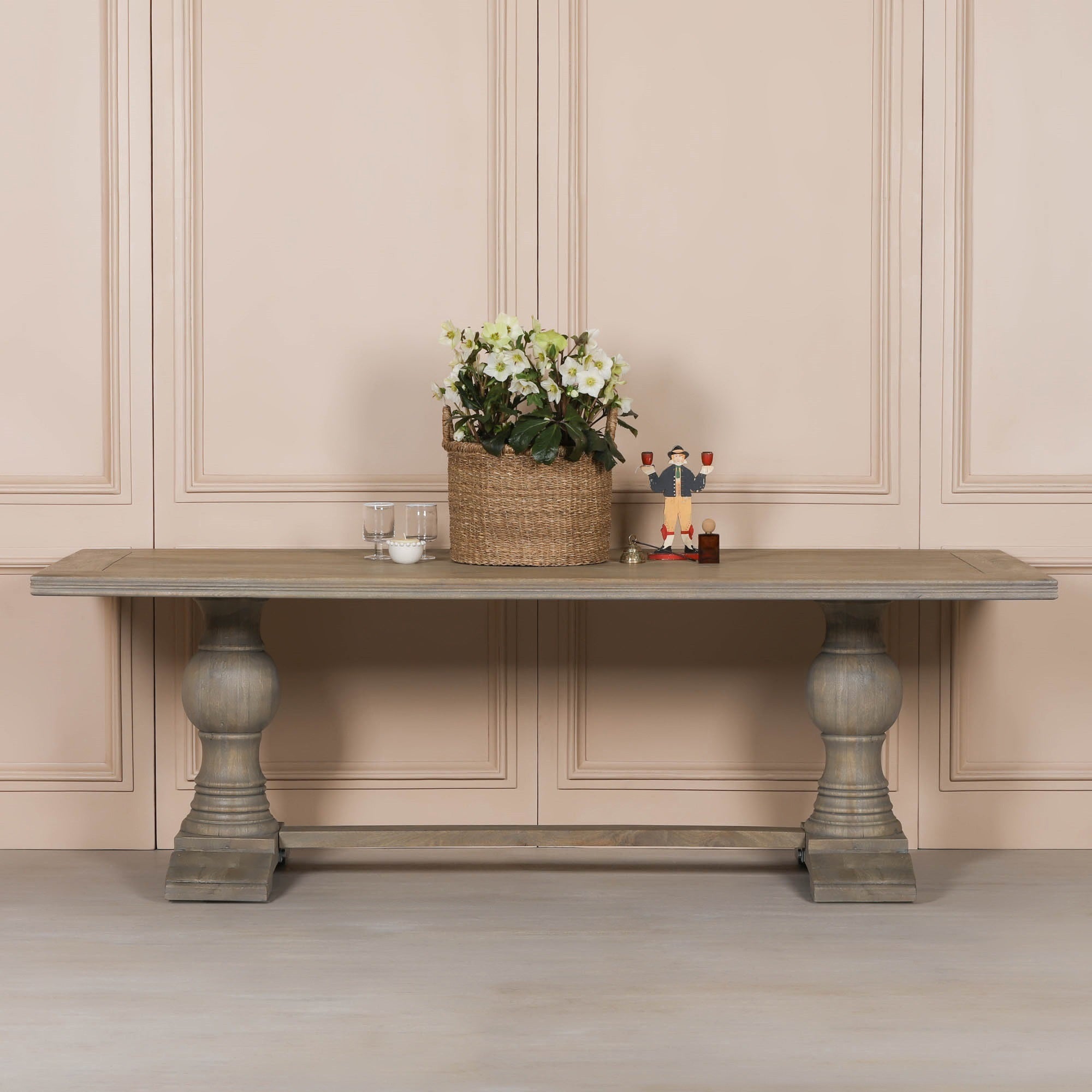 Théodore Large Rectangular Dining Table 240cm for 10–12 in Rustic Mango Wood styled with decorative accessories, showcasing the expansive solid mango wood tabletop, sculptural turned pedestal legs, trestle stretcher base and timeless design for luxury family dining rooms and entertaining.