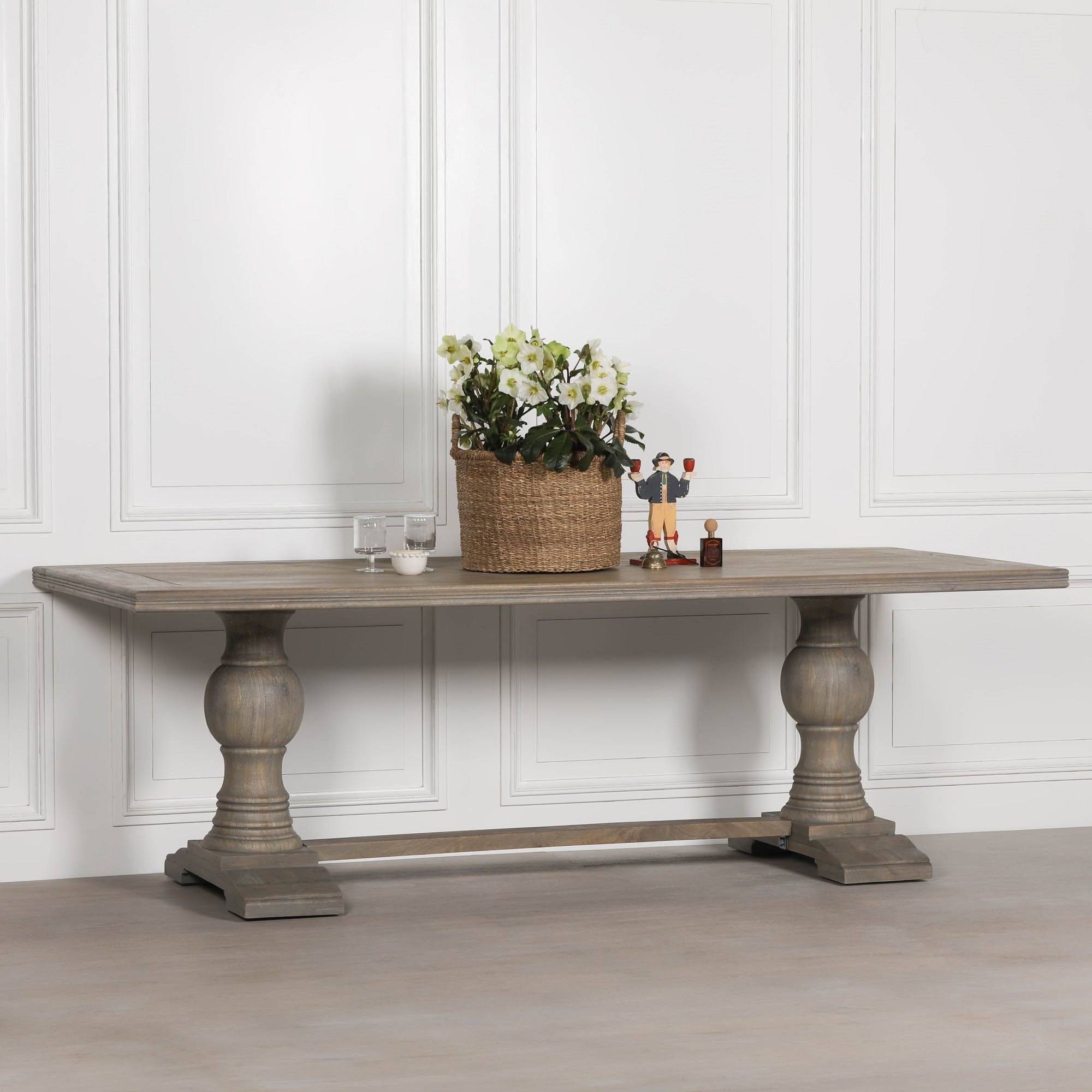 Styled Théodore Large Rectangular Dining Table 240cm for 10–12 in Rustic Mango Wood displaying decorative accessories, emphasising the handcrafted solid mango wood construction, oversized rectangular tabletop and classic pedestal design.