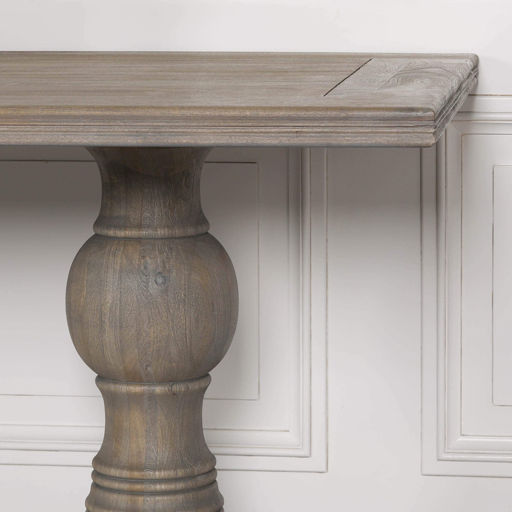 Detailed close-up of the Théodore Large Rectangular Dining Table 240cm featuring the Rustic Mango Wood tabletop, carved edge profile, sculptural turned pedestal leg and natural wood grain for premium handcrafted dining furniture.