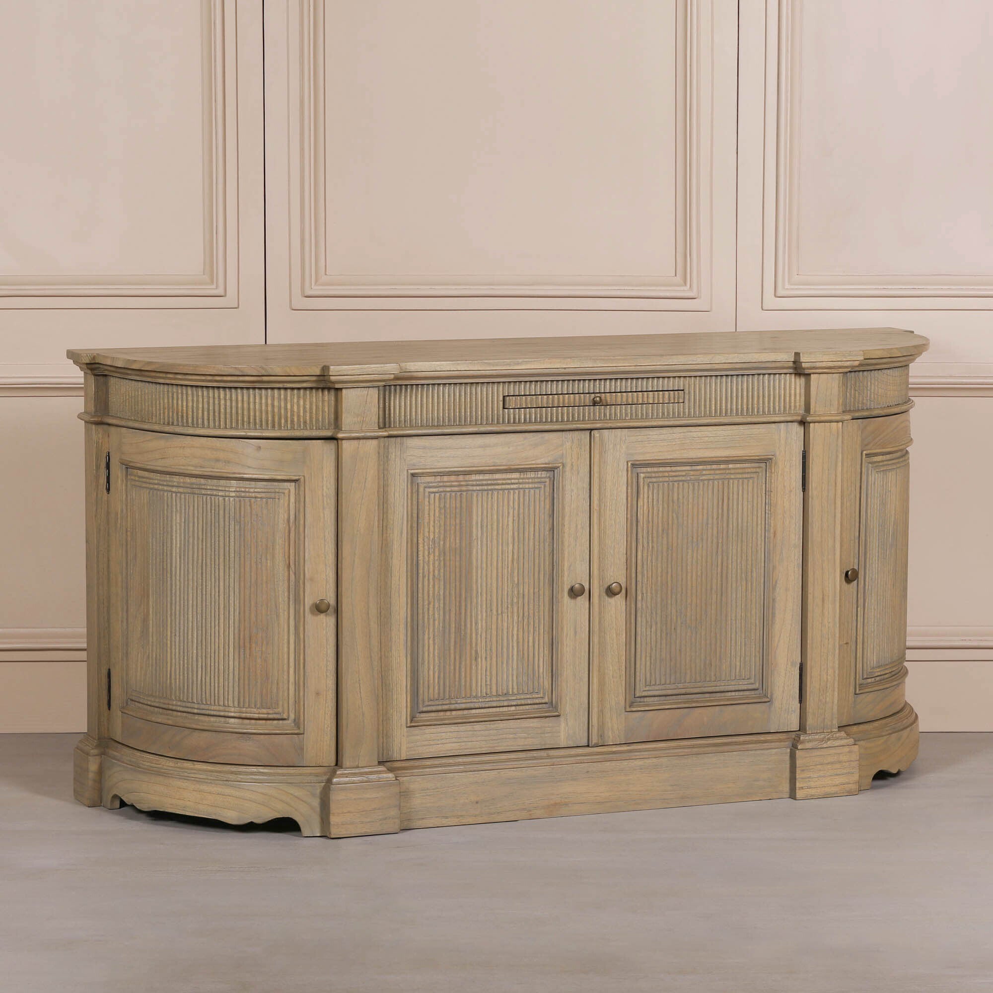 Angled view of the Théodore Rustic Fluted Buffet Sideboard in hand-carved white cedar wood featuring curved end panels, fluted detailing and spacious four-door storage for luxury interiors.