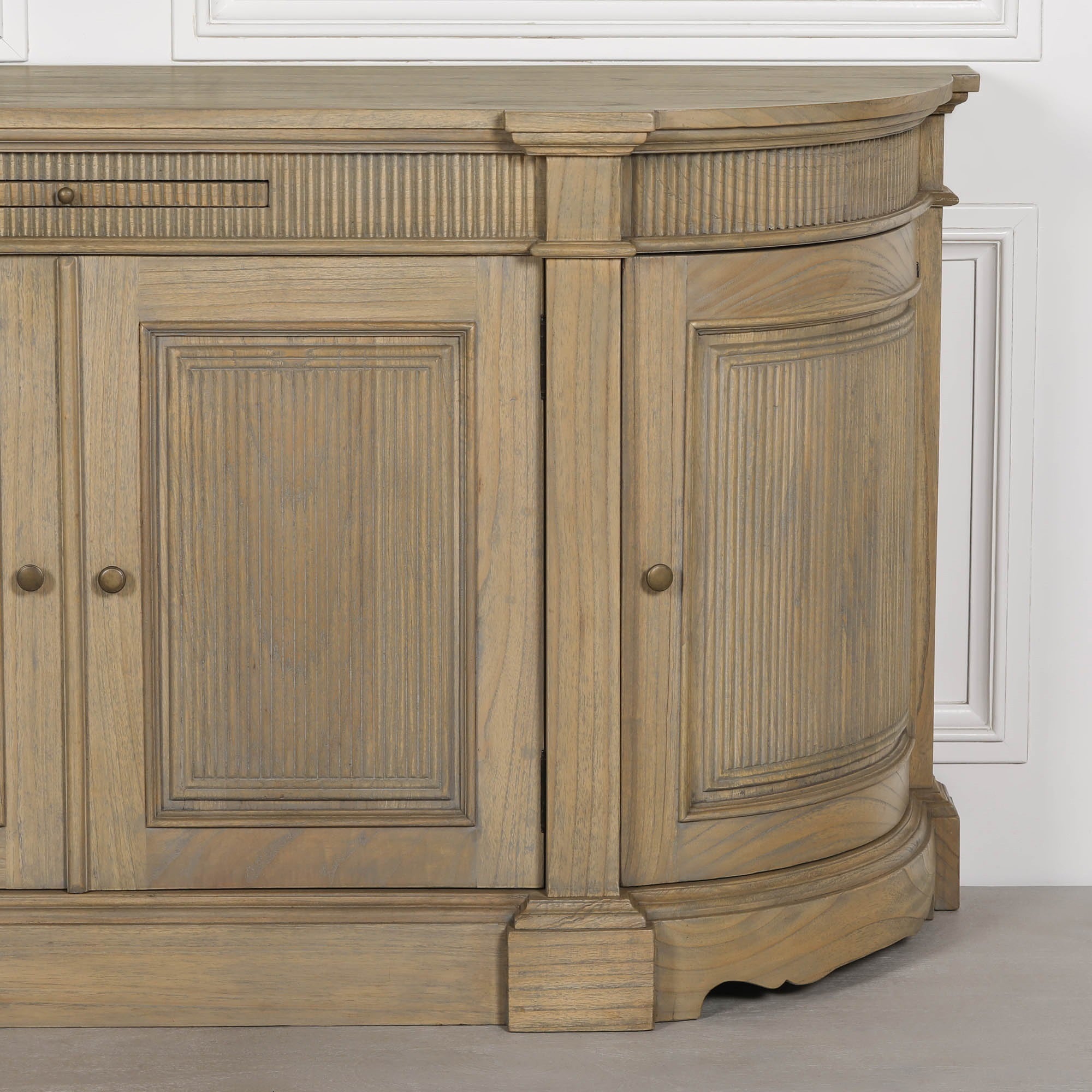 Close-up of the Théodore Rustic Fluted Buffet Sideboard showing the hand-carved fluted cabinet door, curved end panel, white cedar wood grain and premium artisan finish.