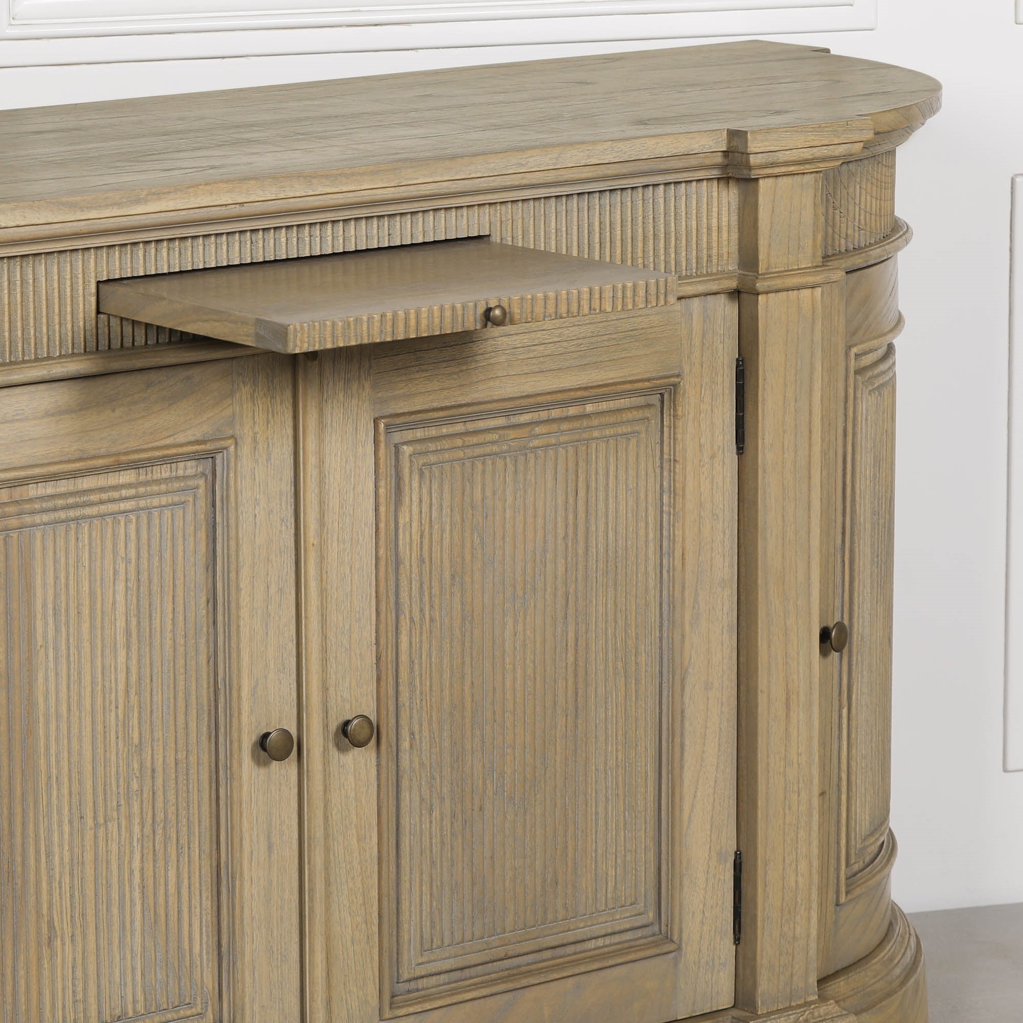 Close-up of the Théodore Rustic Fluted Buffet Sideboard featuring the integrated pull-out serving shelf, hand-carved fluted detailing, curved cabinet profile and white cedar wood construction.
