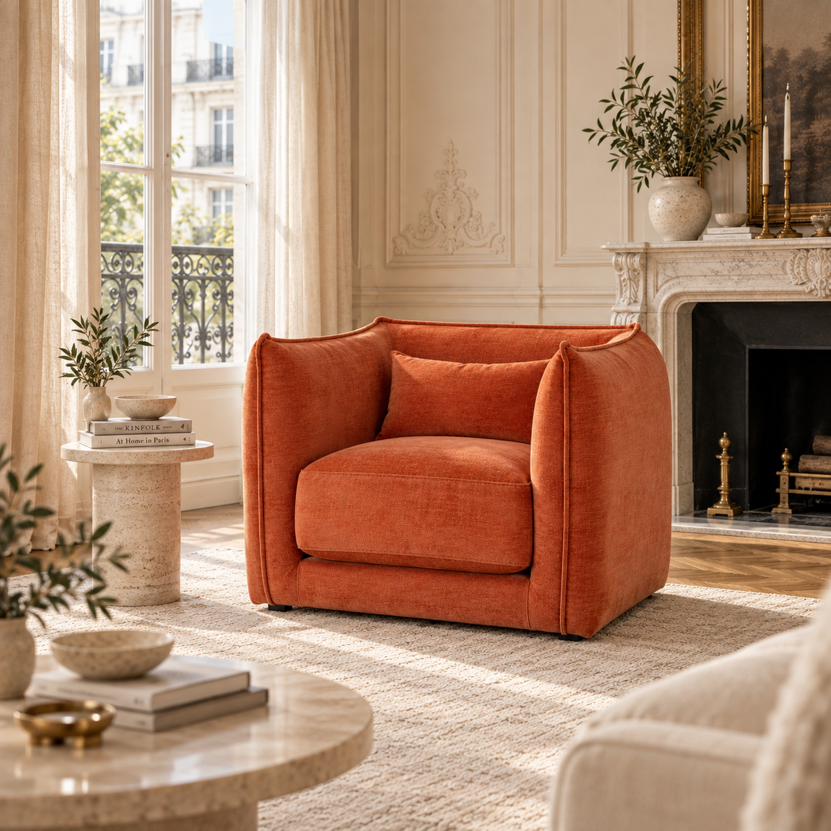 Thibault rust upholstered armchair with cushioned seat in a Parisian living room with marble fireplace, rug and side table