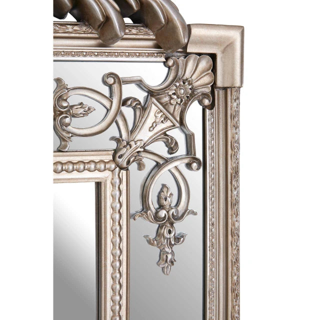 Close-up of Valère champagne gilded wall mirror showing floral corner scrollwork and beaded trim on white.