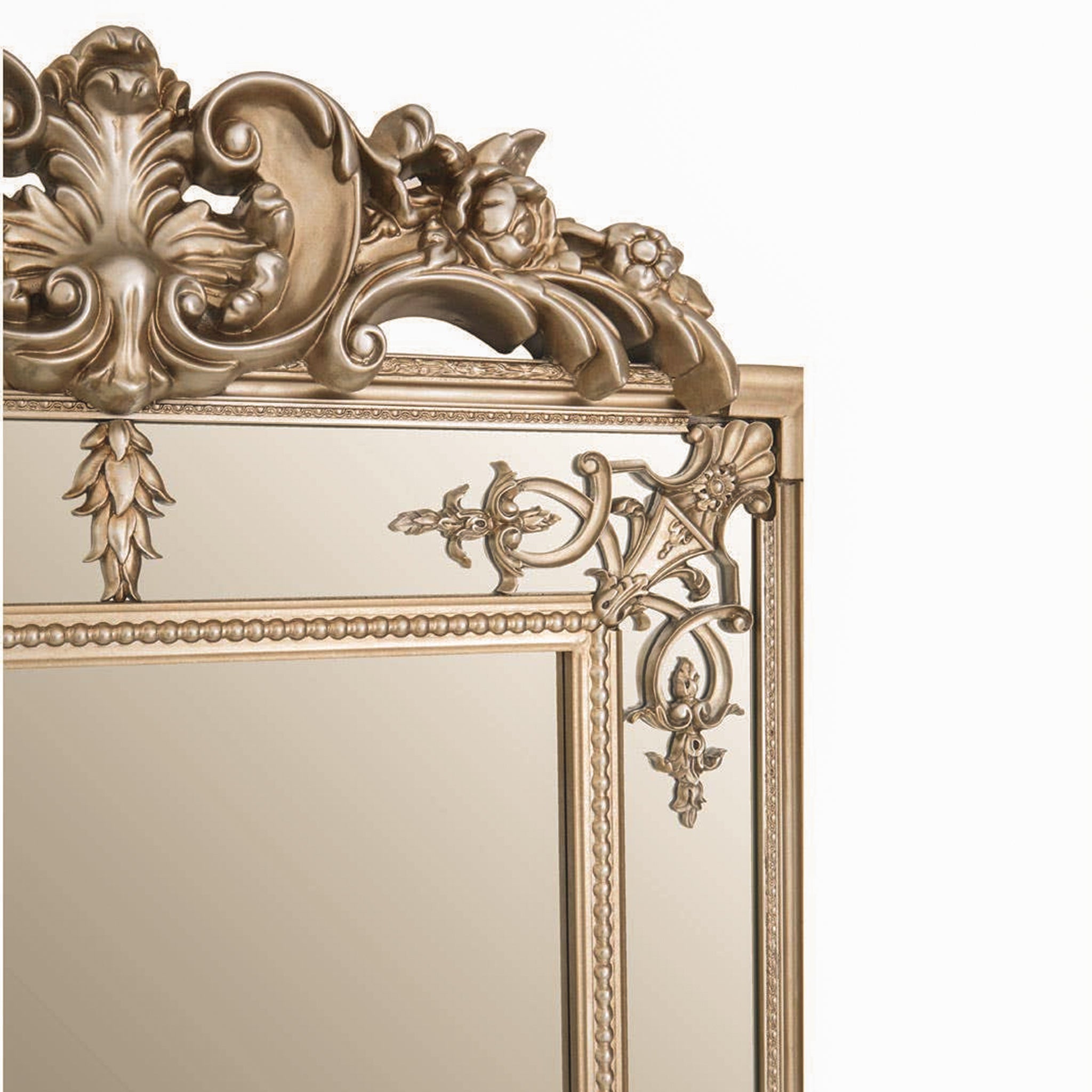 Close-up of the Valère Ornate Champagne Gilded Wall Mirror highlighting its elaborate sculpted crest, floral motifs, scrolling decoration and detailed gilded frame.