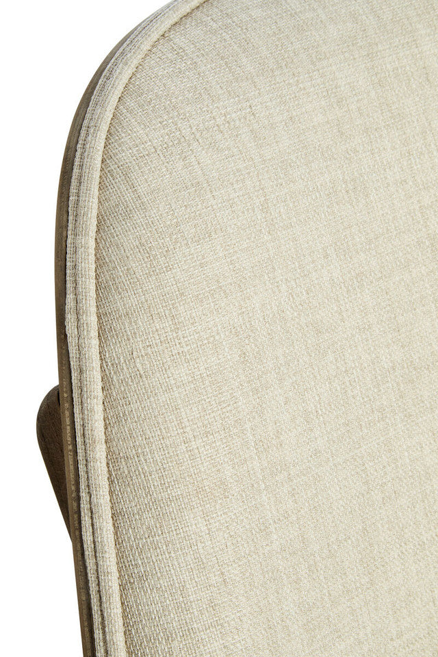Close-up of the Vincent Lounge Chair highlighting the textured beige fabric upholstery, tailored piping, premium stitching and luxurious upholstery craftsmanship.