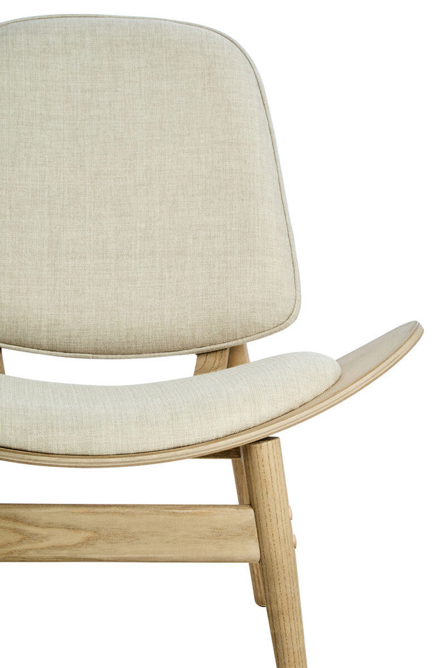 Close-up of the Vincent Lounge Chair featuring the upholstered beige fabric backrest, curved cushioned seat and sculpted washed solid elm wood frame with refined mid-century modern detailing.