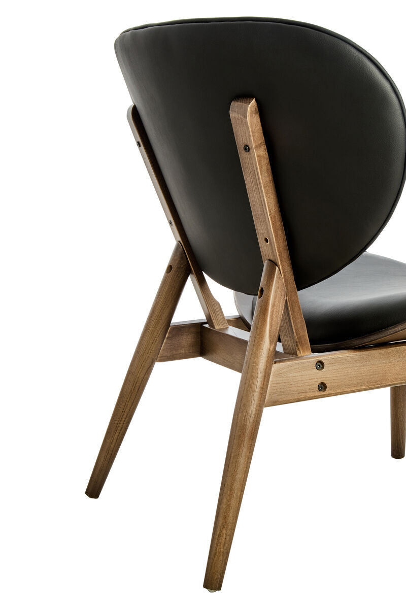 Rear angled view of the Vincent Tufted Lounge Chair highlighting the smooth black leather effect backrest, exposed solid elm wood frame and distinctive mid-century modern craftsmanship.