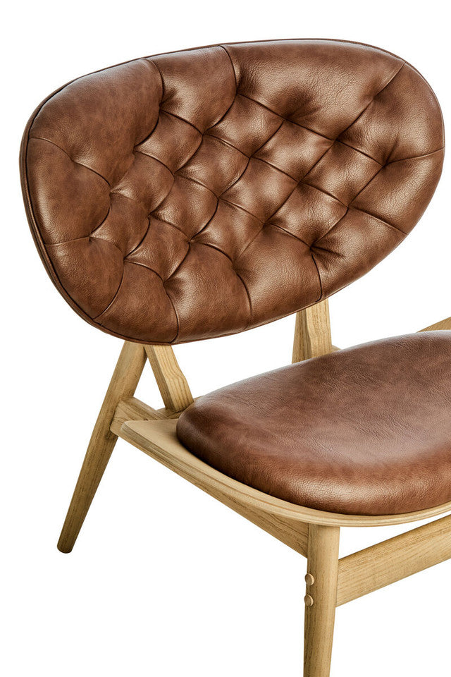 Close-up of the Vincent Tufted Lounge Chair showcasing the button tufted brown leather effect backrest, supportive curved design and solid elm wood frame construction.