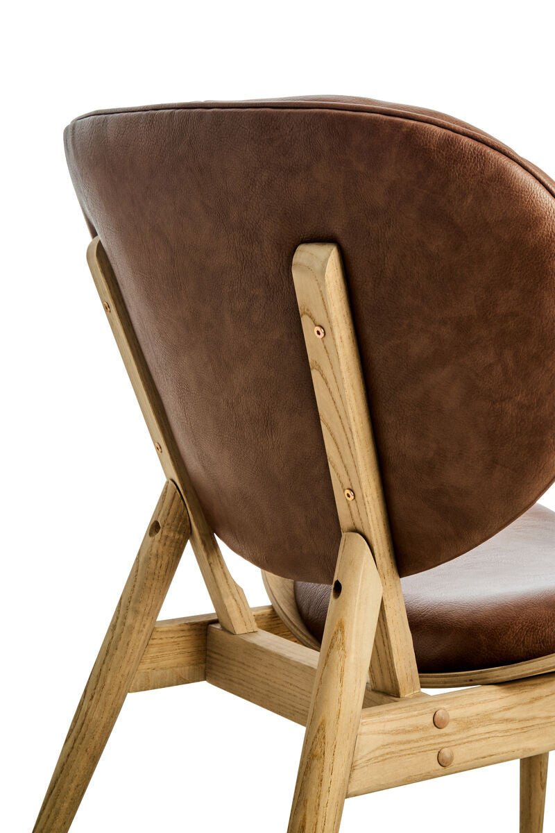 Rear angled view of the Vincent Tufted Lounge Chair displaying the smooth brown leather effect back, exposed solid elm wood frame and handcrafted mid-century inspired construction.