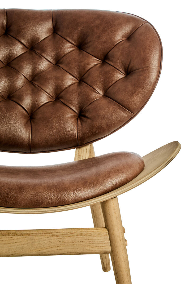 Detailed view of the Vincent Tufted Lounge Chair highlighting luxurious brown leather effect upholstery, deep button tufting, curved silhouette and premium craftsmanship.