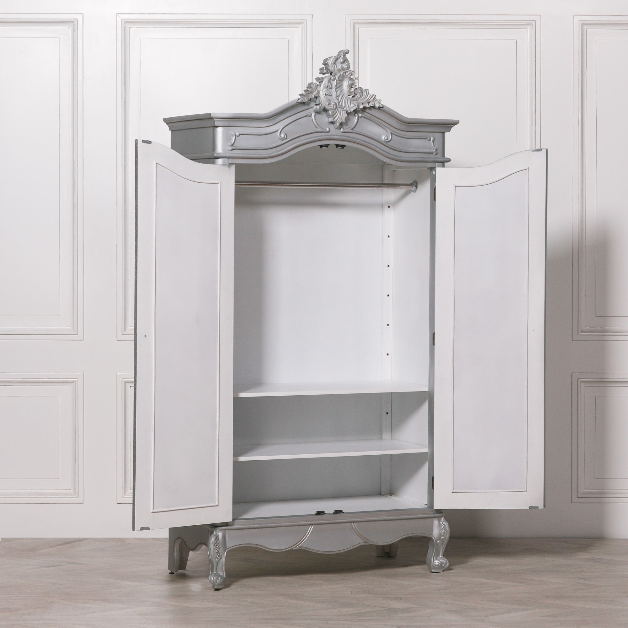 Vivienne Silver Carved Mirrored Double Door Armoire Wardrobe with doors open revealing the spacious hanging rail, adjustable shelving, generous internal storage and elegant French-style bedroom organisation.