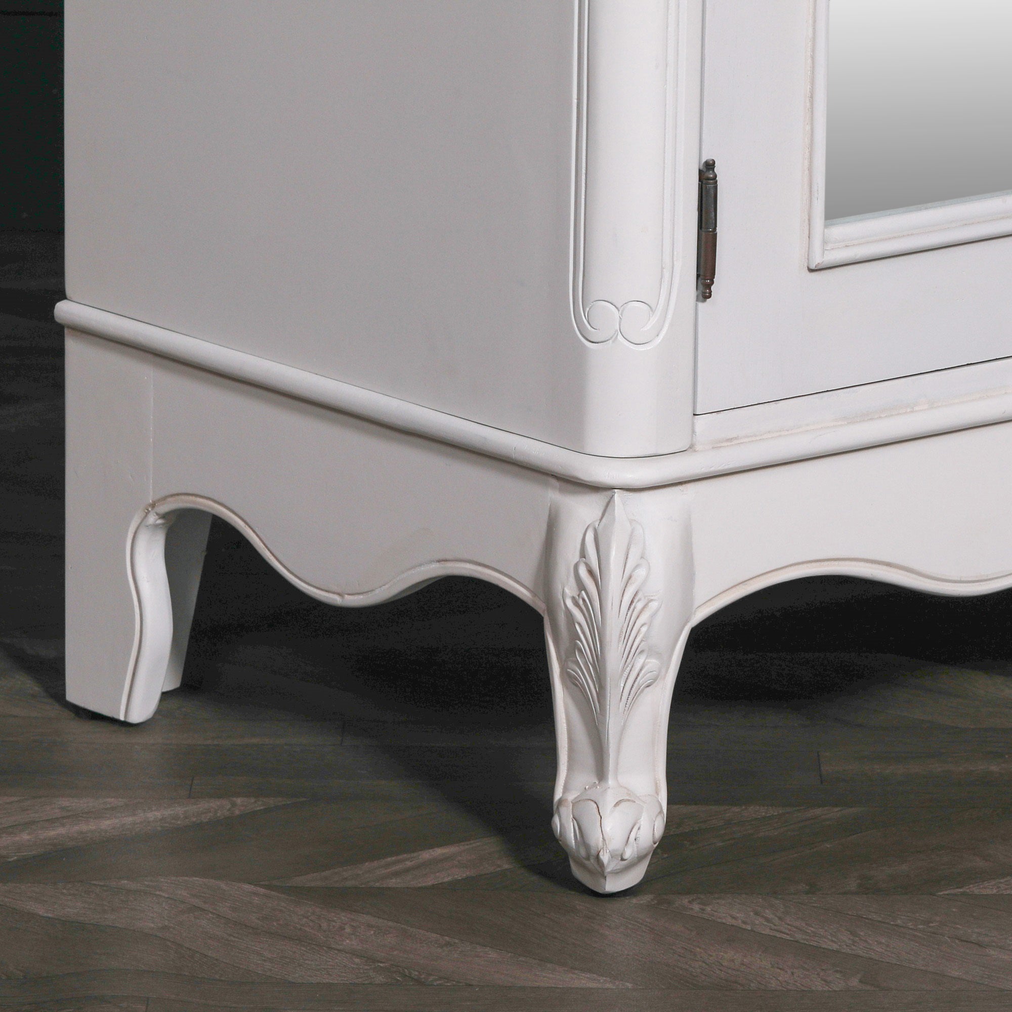 Close-up of the Vivienne White Carved Mirrored Double Door Armoire Wardrobe featuring intricately carved cabriole feet, decorative apron, painted white finish and traditional French craftsmanship.