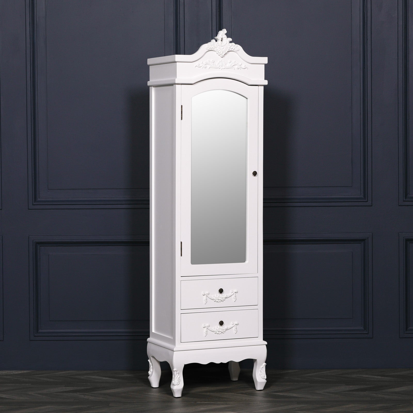 Angled view of Vivienne white mirrored armoire with 2 drawers against a dark navy panelled wall.